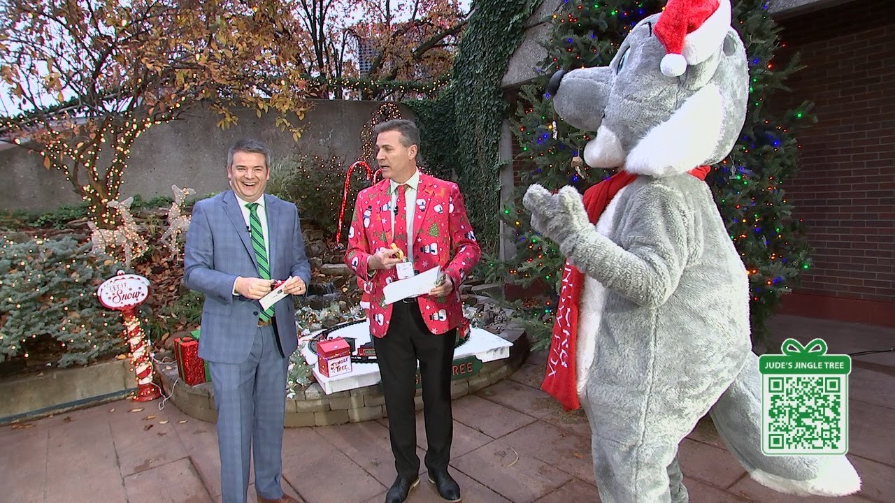 Snow Fox joins in to help Jude hang more ornaments on the Jingle Tree