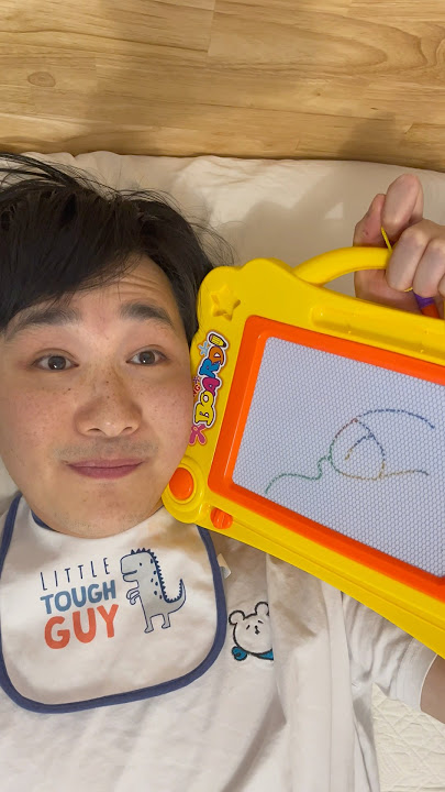 Baby draws on the magna doodle for the first time