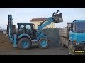 CAT 444F2 backhoe loading TATRA Terrno1 truck