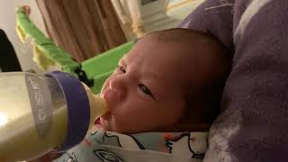 Baby tries bottle feeding for the first time