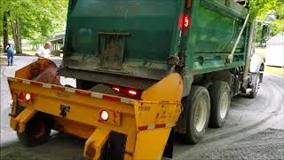 Spreading gravel with a skid loader, epoke and mac truck