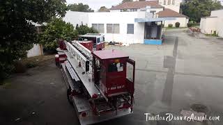 Tiller Truck Makes Tight U-Turn Behind Industrial Building