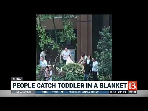 People Catch Toddler in a Blanket