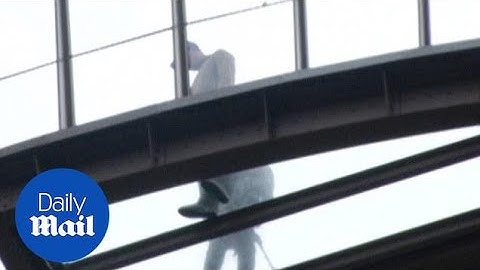Tourists walk on the 200ft high glass floor at the Eiffel Tower - Daily Mail