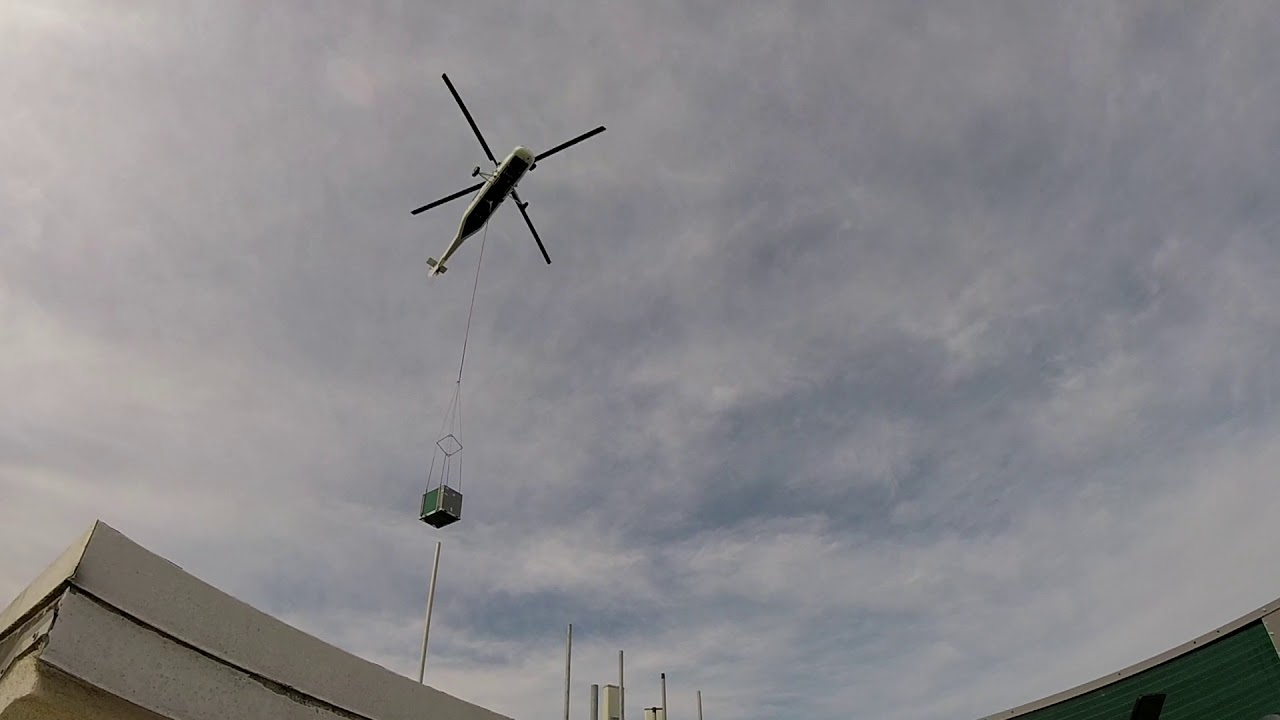 Mills Heating and Air with AIRCRANE lifting the last of many Carrier