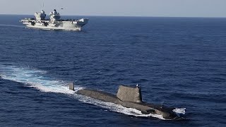 HMS Queen Elizabeth at sea with an Astute-class submarine