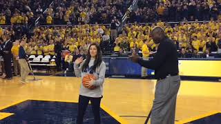 Katelynn Flaherty receives basketball from Glen Rice after becoming Michigan's all-time leading s...