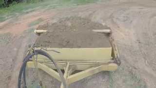 JD 4520 compact utility pulling a dirt pan