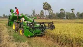 Mini combine harvester working at johndeere 5310