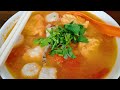 Most Tasty Tomato Seafood Soup with homemade fish balls, fish puffs served with rice noodle