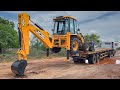 Our brand new jcb 3dx super 4x4 unloading from truck in jcb showroom 2024