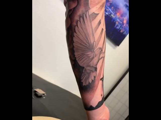 Dove, cross, sun rays black and grey tattoo sleeve by Marvin Rivera - Mariposa Tattoo Studio class=