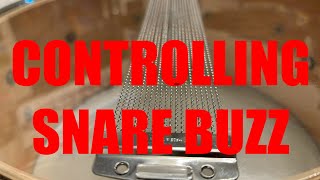 Controlling snare drum buzz