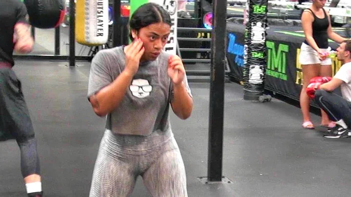 Amateur lady boxer shadowboxing inside the Mayweat...