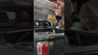 Guy jumps over pickup truck inside CrossFit gym then gets leg stuck in cab