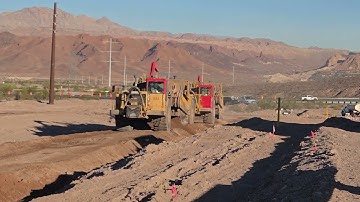 Scraper CAT model 657E complete cycle - loading, hauling, and unloading