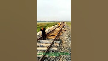 Manual Railway Sleeper Installation: Workers at Work