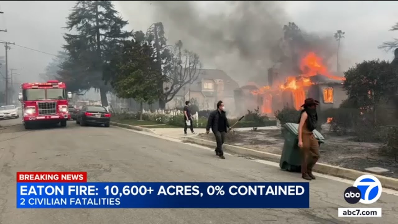Altadena residents fill trash cans with water to help put out flames in neighboring houses