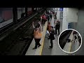 The astonishing moment a man suddenly collapses and flips off a station platform and onto the tracks