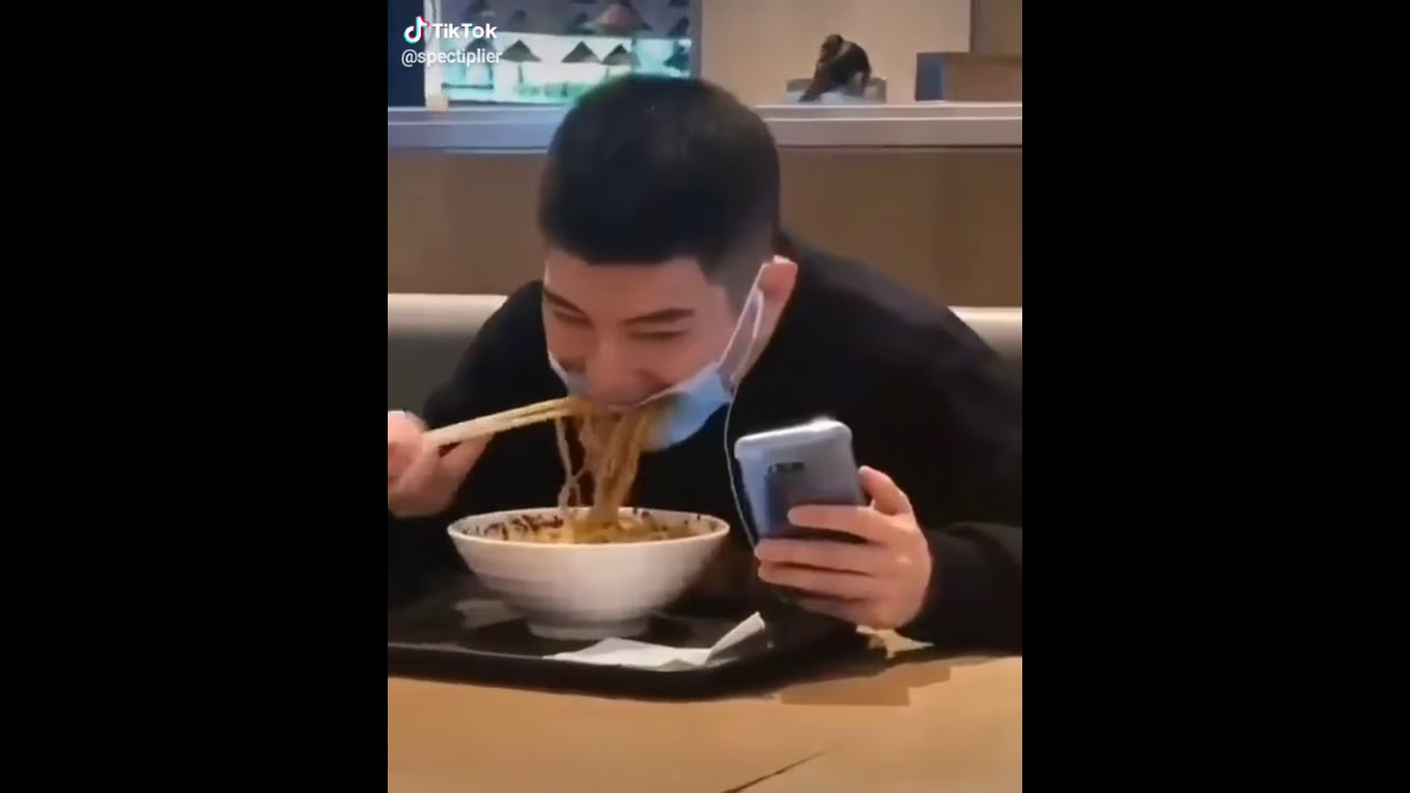 Guy tries to eat food through mask