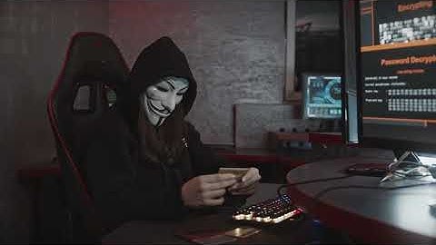 Person in Guy Fawkes Mask Using Computer