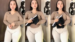 Beautiful mom selling thick, stretchy trousers at a promotional price