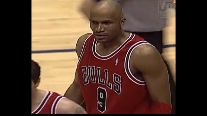 Chicago Bulls - Dennis Rodman #91, Michael Jordan #23, and Scottie Pippen  #33 of the Chicago Bulls look on from the sideline during a 1996 NBA game.