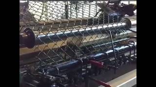 A quick glance at how chain link fence fabric is woven together and palletized in rolls. The sound of wire strand being pulled and 