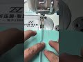 Sewing light blue fabric with pink thread using industrial machine