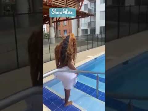 beautiful black woman shows off bikini by the poolside