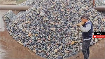 Barge unloading cobblestone.  smooth cobblestone flow