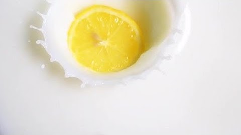 Lemon Slice Falling Into Milk Stock Video