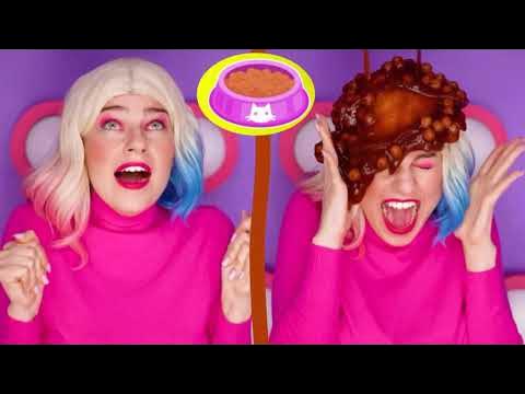 CC3 - Harley Quinn hair gunged with cat food - A clip from a colourful channel, with a young woman with Harley Quinn hair getting gunged with smelly cat food while sitting in a mystery buttons box.