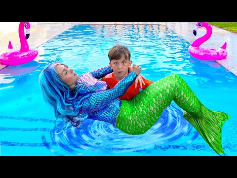 Видео: Senya and Mermaid Swim and Play in the Pool