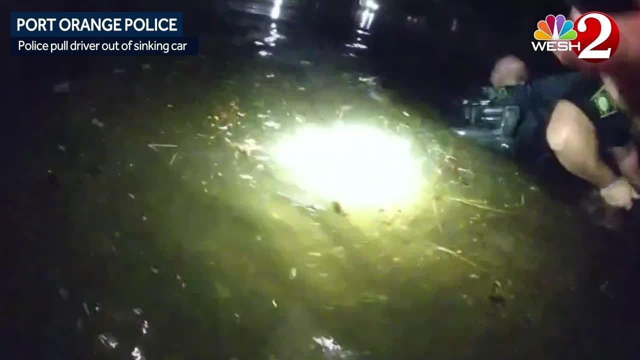 Port Orange officers pull woman from car sinking into canal - YouTube