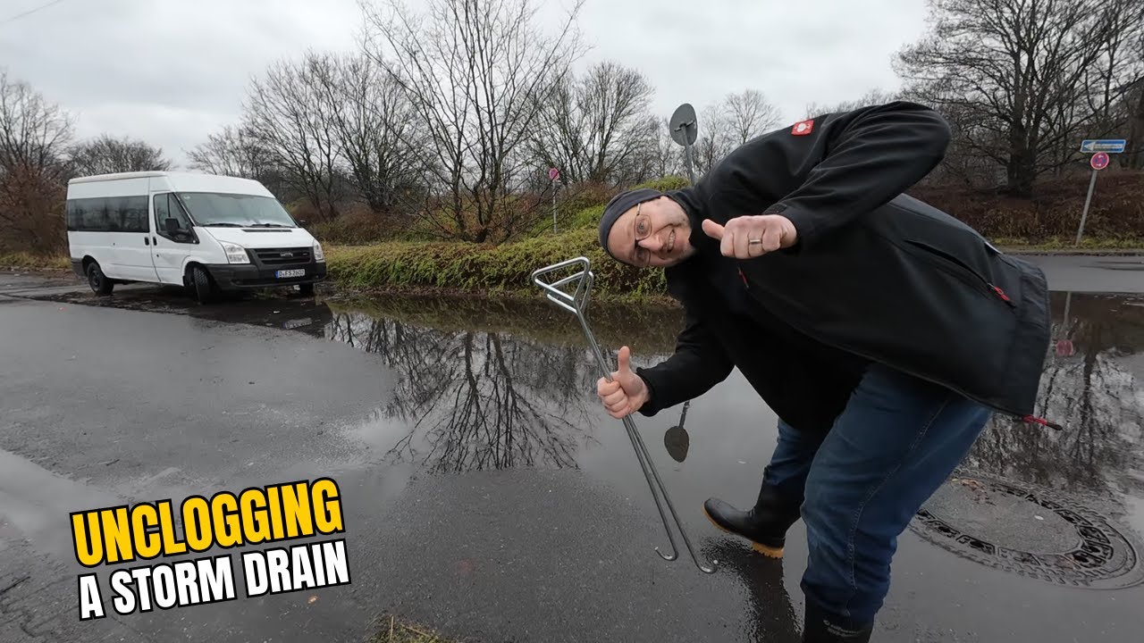 #061-2 Unclogging a storm drain on a parking space after rain in ...