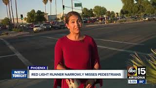 Red-light runner nearly hits family pushing stroller