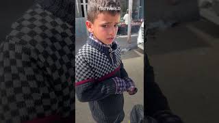 Palestinian child cries for dropping his food