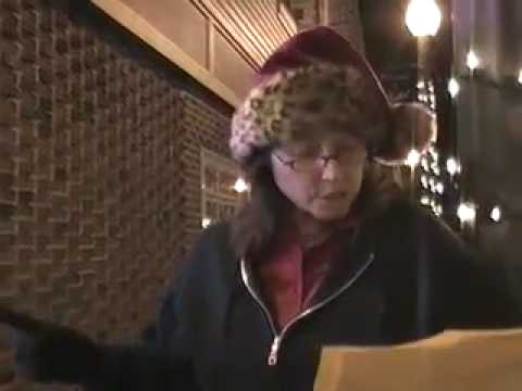 Poet Sandra Mally sings in a Santa Hat