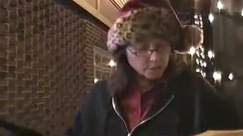 Poet Sandra Mally sings in a Santa Hat
