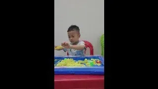 Baby Tom playing sand