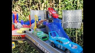 Different Cars racing through Disney Cars Iconic Jump Playset