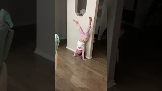 Jasmine doing a splits handstand