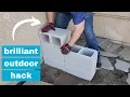 He stacks cinder blocks in his front yard for a brilliant outdoor furniture idea