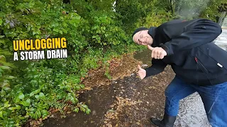 #080-1 Unclogging a storm drain on a parking space after rain in Germany