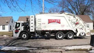 Rumpke picking up trash truck rear loader