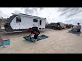 Folding a Mats By Design mat with 2 people