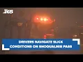 Drivers navigating snow slick conditions on I-90