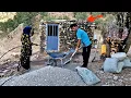 Download Lagu A young man helps a family in the mountains build a roof for their house.