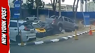 Wild Moment Alleged Drunk Pickup Driver Reverses Into Four Cars in Hospital Parking Lot